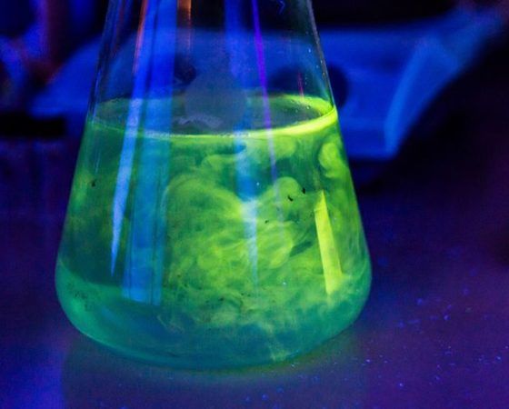 Green light to UV light fluorescing adhesives